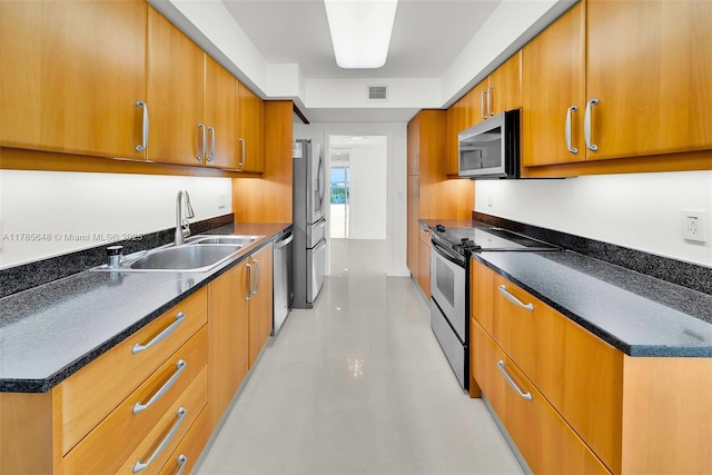 16500 Collins Ave Unit 656, Sunny Isles Beach, FL 33160 - kitchen featuring appliances with stainless steel finishes, a sink, brown cabinetry, dark countertops, and modern cabinets