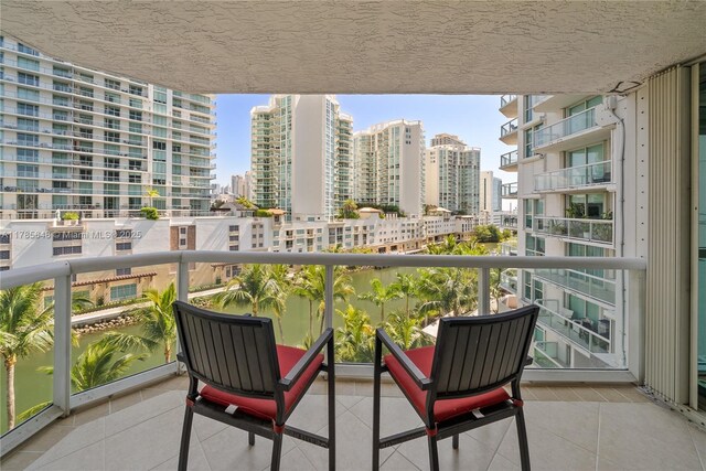16500 Collins Ave Unit 656, Sunny Isles Beach, FL 33160 - empty room featuring a water view, plenty of natural light, tile patterned flooring, and a wall of windows