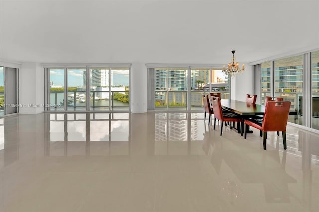 16500 Collins Ave Unit 656, Sunny Isles Beach, FL 33160 - dining area with a chandelier, a wall of windows, a water view, and tile patterned floors