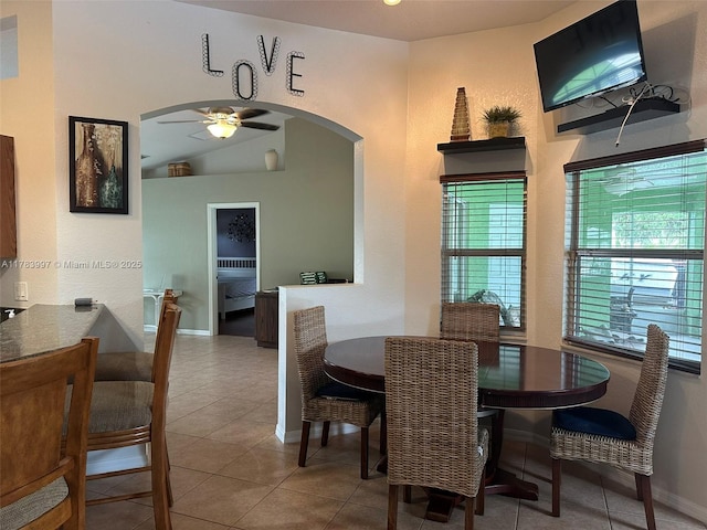 1214 SW Patricia Ave, Port St Lucie, FL 34953 - dining room featuring arched walkways, ceiling fan, tile patterned flooring, and baseboards