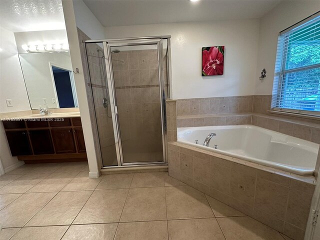 1214 SW Patricia Ave, Port St Lucie, FL 34953 - bathroom featuring vanity, a bath, tile patterned flooring, and a stall shower