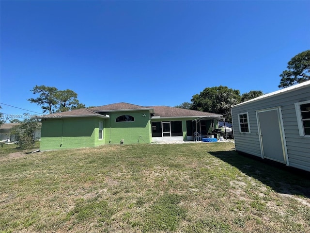 1214 SW Patricia Ave, Port St Lucie, FL 34953 - rear view of house with a sunroom, a lawn, and stucco siding