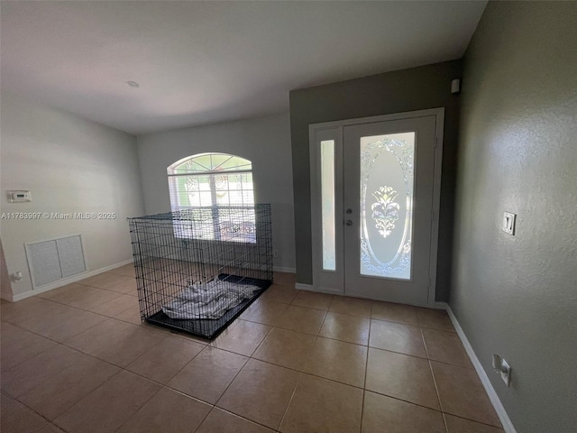 1214 SW Patricia Ave, Port St Lucie, FL 34953 - entrance foyer featuring tile patterned flooring, visible vents, and baseboards