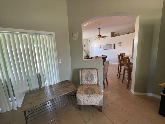 1214 SW Patricia Ave, Port St Lucie, FL 34953 - living area with arched walkways, ceiling fan, baseboards, and tile patterned floors