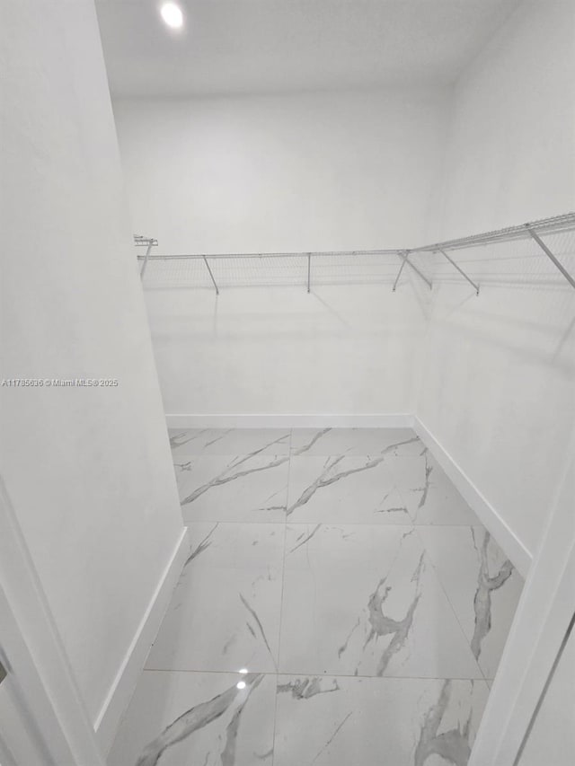 497 Lenox Ave S, Lehigh Acres, FL 33974 - walk in closet featuring marble finish floor