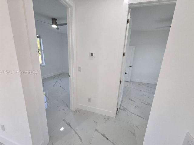 497 Lenox Ave S, Lehigh Acres, FL 33974 - hallway featuring marble finish floor and baseboards