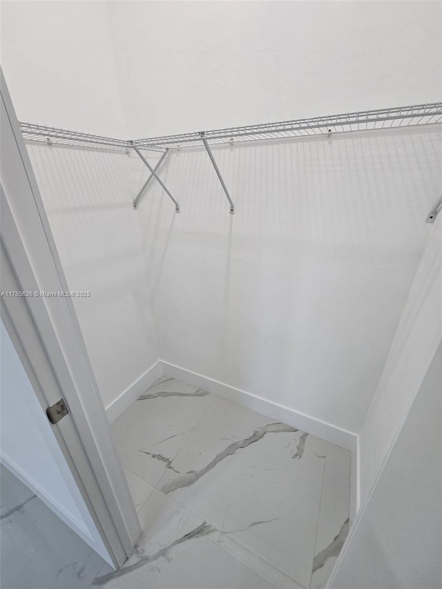 497 Lenox Ave S, Lehigh Acres, FL 33974 - spacious closet featuring marble finish floor