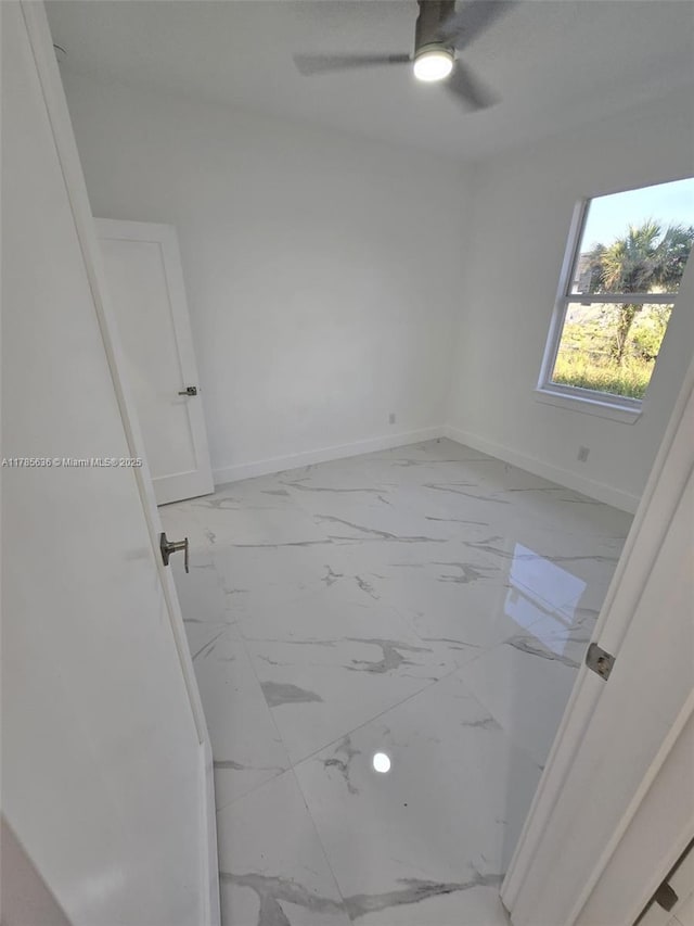 497 Lenox Ave S, Lehigh Acres, FL 33974 - unfurnished room featuring baseboards, marble finish floor, and ceiling fan