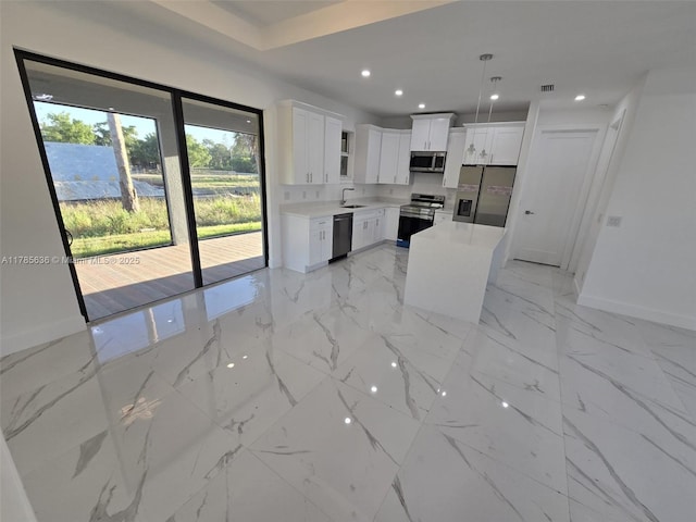 497 Lenox Ave S, Lehigh Acres, FL 33974 - kitchen featuring baseboards, a sink, light countertops, appliances with stainless steel finishes, and white cabinetry