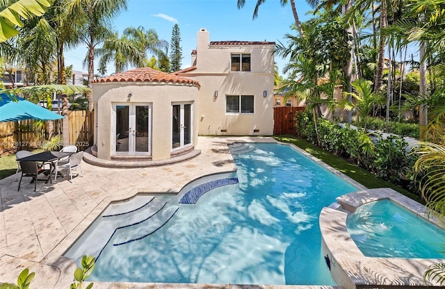 view of pool featuring a patio, french doors, a fenced backyard, and a fenced in pool
