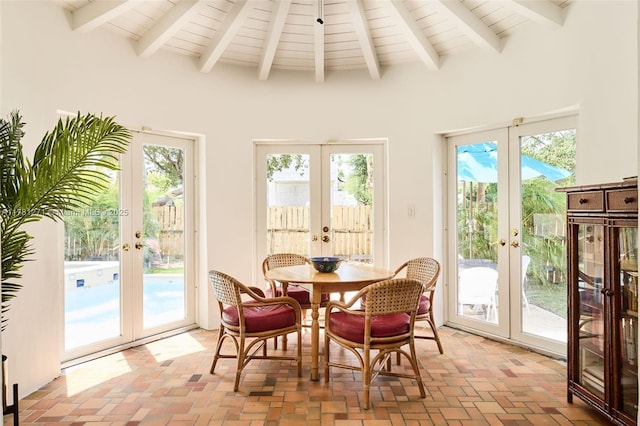 sunroom / solarium featuring french doors and beam ceiling
