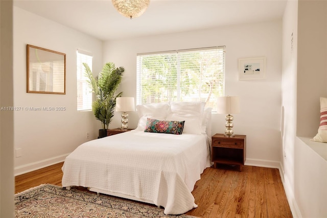 bedroom with baseboards and wood finished floors