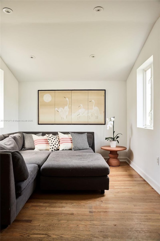 living area featuring recessed lighting, baseboards, wood finished floors, and lofted ceiling