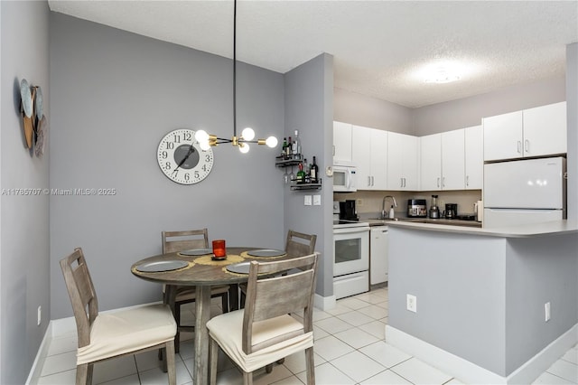 9660 S Belfort Cir Unit 207, Tamarac, FL 33321 - kitchen with white appliances, a sink, white cabinets, a chandelier, and a textured ceiling
