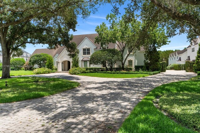 6320 Hancock Rd, Southwest Ranches, FL 33330 - view of front facade featuring driveway, a front lawn, a chimney, and stucco siding