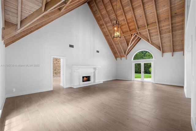 6320 Hancock Rd, Southwest Ranches, FL 33330 - unfurnished living room featuring french doors, wooden ceiling, high vaulted ceiling, healthy amount of natural light, and a chandelier