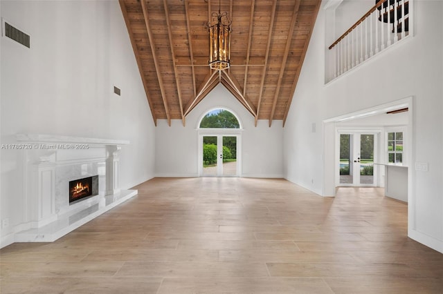 6320 Hancock Rd, Southwest Ranches, FL 33330 - unfurnished living room featuring french doors, a wooden ceiling with exposed beams, high vaulted ceiling, healthy amount of natural light, and a chandelier