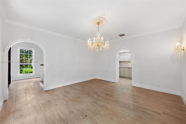 6320 Hancock Rd, Southwest Ranches, FL 33330 - spare room with arched walkways, ornamental molding, a chandelier, and light wood-style flooring