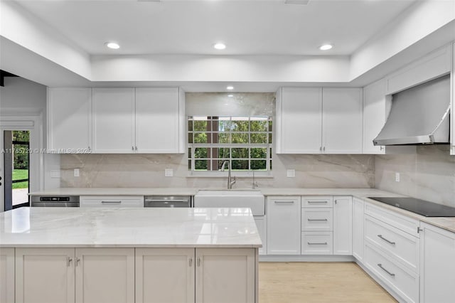 6320 Hancock Rd, Southwest Ranches, FL 33330 - kitchen with black electric stovetop, wall chimney range hood, white cabinets, light stone counters, and recessed lighting