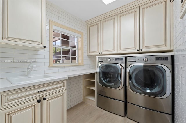 6320 Hancock Rd, Southwest Ranches, FL 33330 - laundry room with washer and clothes dryer, cabinet space, tile walls, and light wood-type flooring