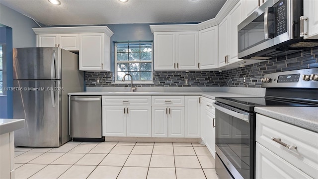 5010 SW 201st Ter, Southwest Ranches, FL 33332 - kitchen with stainless steel appliances, white cabinets, light countertops, decorative backsplash, and a textured ceiling