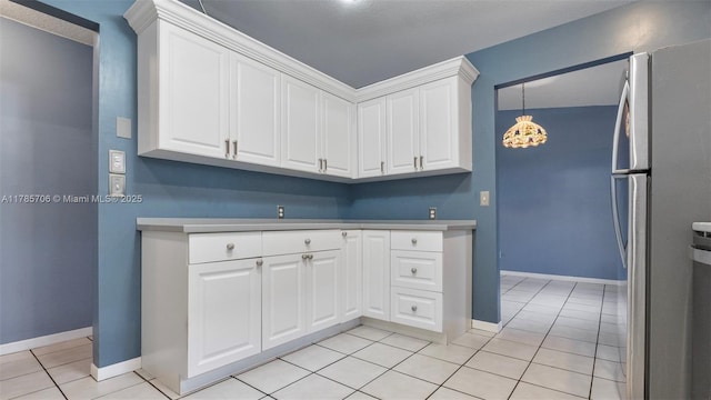 5010 SW 201st Ter, Southwest Ranches, FL 33332 - kitchen featuring freestanding refrigerator, white cabinetry, light countertops, light tile patterned floors, and a chandelier