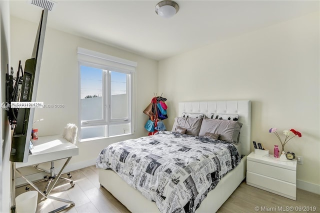 10550 NW 63rd Ter, Doral, FL 33178 - bedroom featuring baseboards, visible vents, and light wood-type flooring