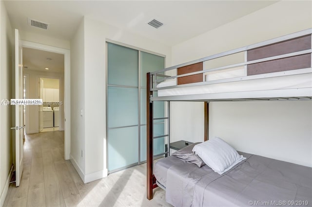 10550 NW 63rd Ter, Doral, FL 33178 - bedroom with separate washer and dryer, visible vents, a closet, and light wood-type flooring