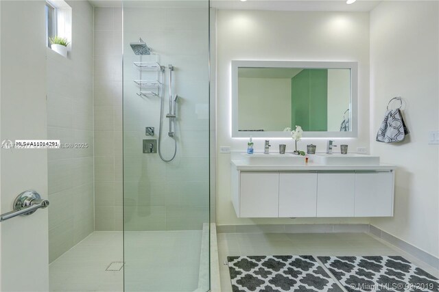 10550 NW 63rd Ter, Doral, FL 33178 - bathroom with baseboards, a sink, double vanity, and tiled shower
