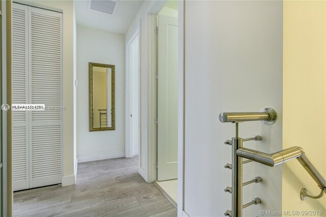 10550 NW 63rd Ter, Doral, FL 33178 - hall featuring visible vents, baseboards, and light wood-style floors