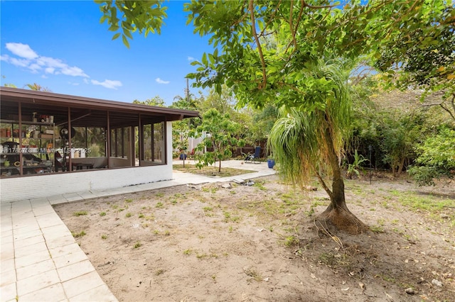 view of yard featuring a sunroom