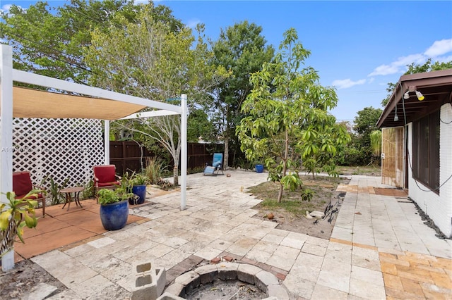 view of patio / terrace with fence and a fire pit