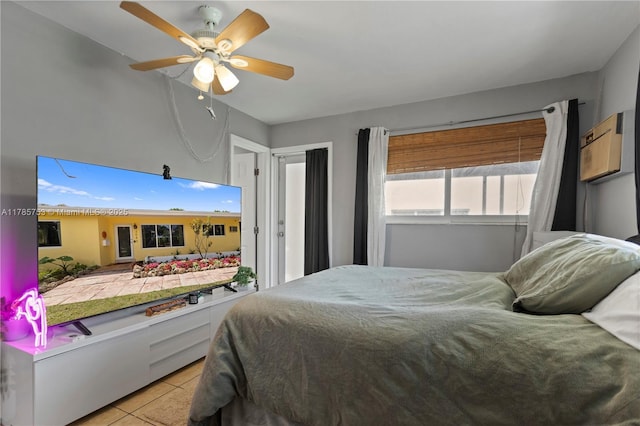 bedroom with ceiling fan and light tile patterned floors