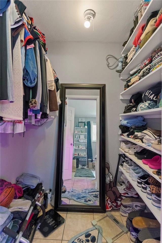 spacious closet with tile patterned floors