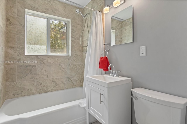 bathroom featuring vanity, toilet, and shower / bath combo