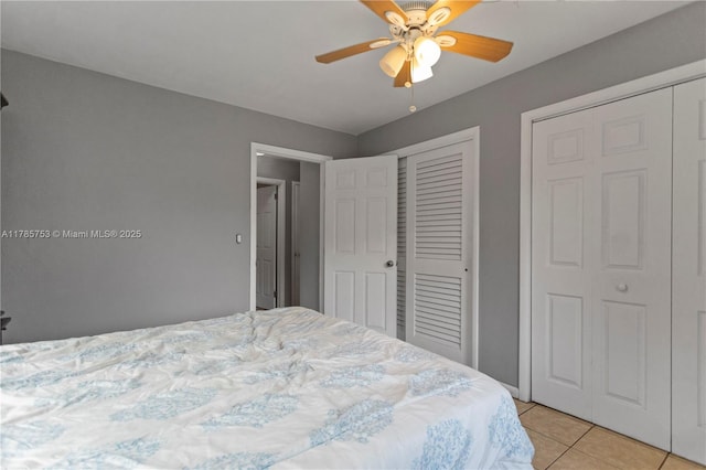 bedroom with ceiling fan and light tile patterned flooring