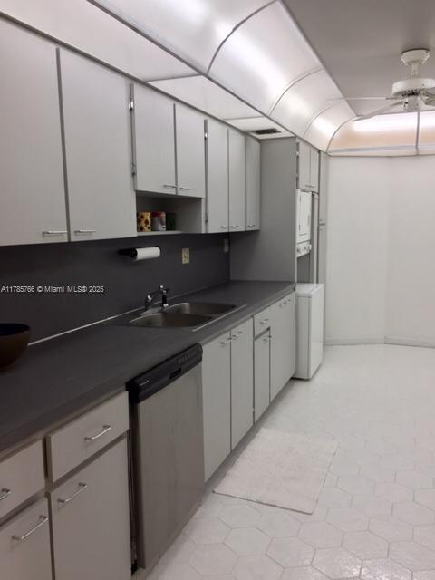 1111 Crandon Blvd Unit B804, Key Biscayne, FL 33149 - kitchen featuring stainless steel dishwasher, washer / clothes dryer, a sink, dark countertops, and ceiling fan