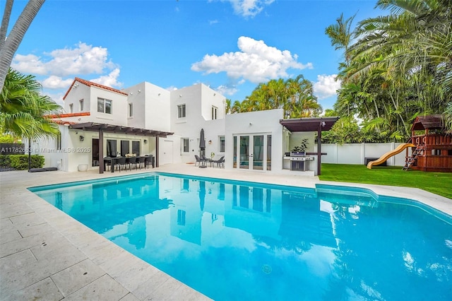 view of pool with fence, a pergola, a fenced in pool, and french doors
