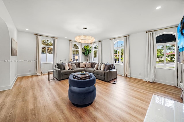 living room with recessed lighting, light wood-type flooring, and baseboards