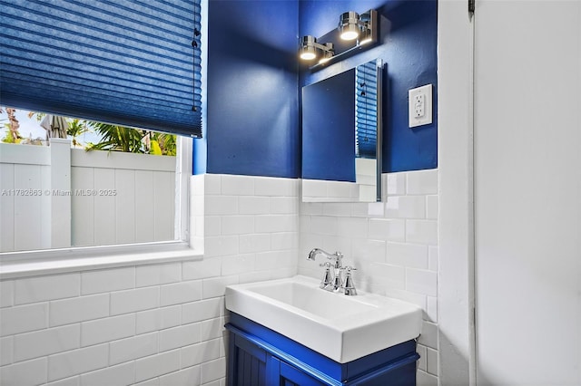 bathroom with vanity and tile walls