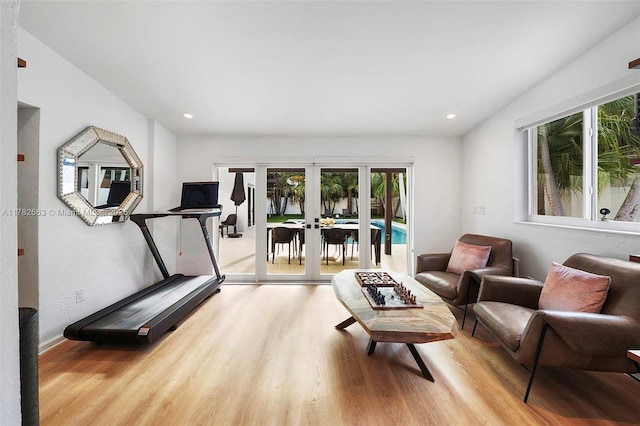 workout room with french doors, wood finished floors, and recessed lighting