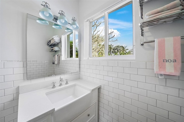 bathroom with tile walls and vanity
