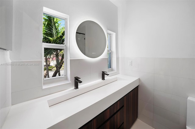 bathroom featuring tile walls and vanity