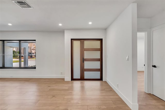 entrance foyer featuring light wood-type flooring, baseboards, visible vents, and recessed lighting