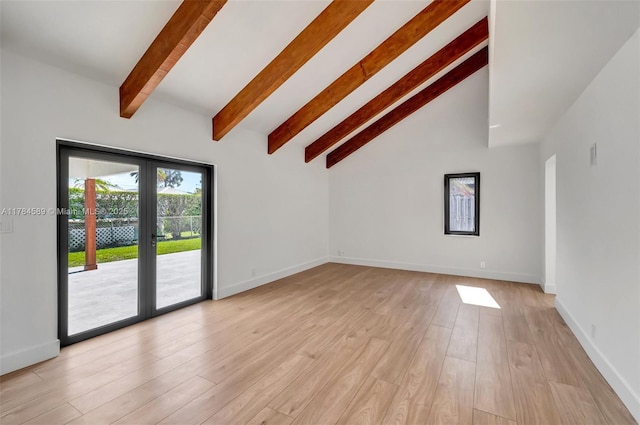 unfurnished living room featuring light wood-type flooring, baseboards, and lofted ceiling with beams