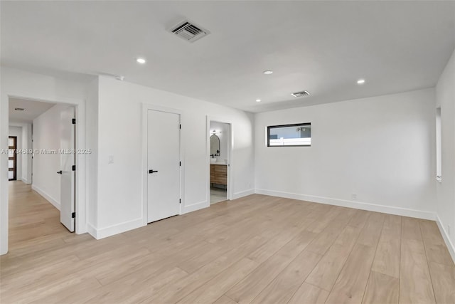 spare room featuring recessed lighting, light wood-type flooring, visible vents, and baseboards