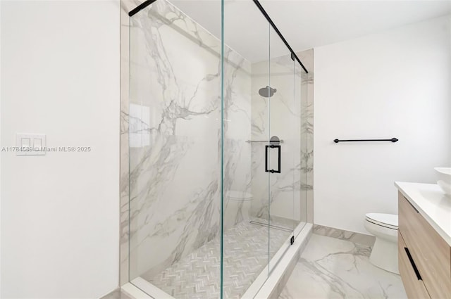 bathroom with vanity, marble finish floor, a marble finish shower, and toilet