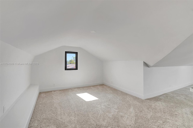 bonus room featuring vaulted ceiling, baseboards, and carpet