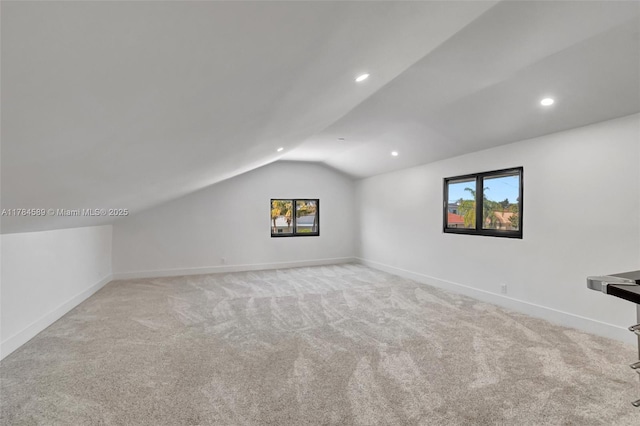 bonus room featuring baseboards, lofted ceiling, carpet flooring, and a wealth of natural light