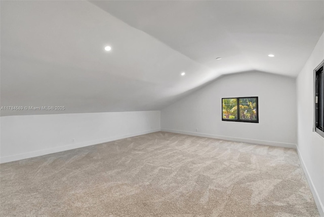 additional living space with recessed lighting, vaulted ceiling, carpet floors, and baseboards